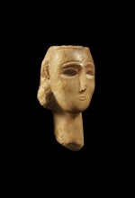 A South Arabian Alabaster Head of a Woman, Qataban, 3rd Century B.C./1st Century A.D.
