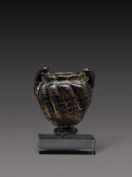 A Late Roman Black and Red Core-Formed Glass Cosmetic Jar, circa 5th/7th century A.D.