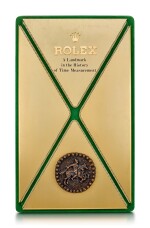 ROLEX | A GILT BRASS AND LEATHER DISPLAY, CIRCA 1970