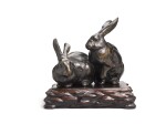 A Japanese bronze model of two hares, Meiji period, late 19th century