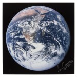 [Apollo 17] — Earth as seen from the Command Module. Color photograph signed and inscribed by Commander Gene Cernan