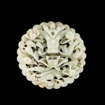 A reticulated white and russet jade 'dragon' plaque, Ming dynasty 明 白玉鏤雕穿花龍紋飾