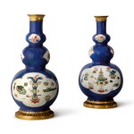 TWO GILT BRONZE-MOUNTED POWDER-BLUE GROUND FAMILLE VERTE TRIPLE GOURD VASES FORMING A PAIR, THE PORCELAIN QING DYNASTY, KANGXI PERIOD (1662-1722), THE MOUNTS MID-18TH CENTURY
