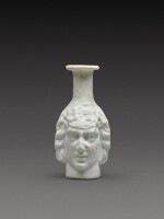 A Roman Opaque White Mould-Blown Janiform Glass Flask, circa 1st/2nd century AD