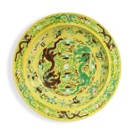 A massive yellow-ground green- and aubergine-enameled 'Chuxiugong' 'dragon' charger, Qing dynasty, Guangxu period, circa 1889 | 清光緒 約1889年 黃地紫綠彩雲龍趕珠紋大盤 《儲秀宮製》款