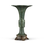 A large spinach-green jade archaistic beaker vase, Gu, Qing dynasty, Qianlong period  | 清乾隆 仿古碧玉饕餮紋花觚