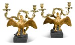 A PAIR OF HERALDIC TERRACOTTA CRESTS ADAPTED AS CANDELABRA, 20TH CENTURY, IN THE FORM OF AN EAGLE IMPALING A SERPANT, WITH GILT-BRASS TWIN-BRANCH CANDLEARMS