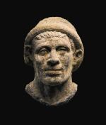 AN ETRUSCAN NENFRO PORTRAIT HEAD OF A MAN, LATE 2ND/EARLY 1ST CENTURY B.C.