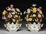 A RARE PAIR OF MEISSEN OVAL MONTEITHS MOUNTED WITH ARRANGEMENTS OF TÔLE-PEINTE AND PORCELAIN FLOWERS, THE MONTEITHS CIRCA 1740, THE TÔLE-PEINTE AND PORCELAIN FLOWERS 18TH CENTURY AND LATER