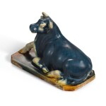AN EXTREMELY RARE BLUE, STRAW AND AMBER-GLAZED BUFFALO, TANG DYNASTY | 唐 三彩加藍臥牛