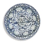 A rare large blue and white moulded 'mandarin duck and lotus pond' dish, Yuan dynasty  |  元 青花荷塘鴛鴦紋花口大盤