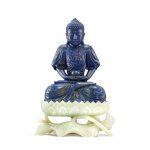 A finely carved and rare lapis lazuli figure of Amitabha Buddha on a white jade lotus stand, Qing dynasty, Qianlong period | 清乾隆 青金石阿彌陀佛坐像連白玉蓮座