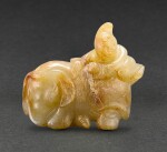 A YELLOW AND RUSSET JADE FIGURE OF A FOREIGNER RIDING AN ELEPHANT YUAN DYNASTY | 元 黃玉胡人戲象把件