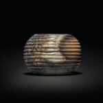 A beige and brown jade ribbed vessel, Zhou dynasty or later | 周或以後 玉弦紋器