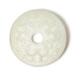 A carved pale celadon jade disc (Bi), 20th century | 二十世紀 青白玉雕仿古紋璧
