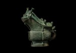 An exceptionally rare archaic bronze ritual wine vessel and cover, gong, Late Shang dynasty | 商末 青銅獸形觥