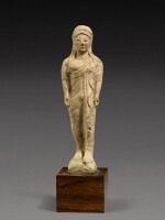 A Greek Terracotta Figure of a Kouros, circa 1st half of the 5th Century B.C.
