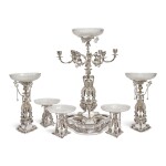 A VICTORIAN SILVER-PLATED AND CUT-GLASS SEVEN-PIECE TABLE GARNITURE, PROBABLY DESIGNED BY A.A. WILLMS, ELKINGTON & CO., CIRCA 1865