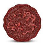 A cinnabar lacquer 'dragon' lobed box and cover, Qing dynasty, Qianlong period 清乾隆 剔紅蒼龍教子葵式蓋盒