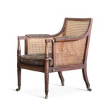 A GEORGE IV MAHOGANY AND CANE LIBRARY ARMCHAIR, CIRCA 1825, IN THE MANNER OF GILLOWS