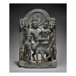  A BLACK STONE FIGURE OF UMA-MAHESHVARA,  WESTERN INDIA, HARYANA, 12TH CENTURY