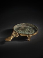 A rare gilt-bronze falcon-shaped candlestick holder, Han dynasty | 漢 銅鎏金燭臺