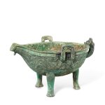 A rare and large archaic bronze ritual pouring vessel, Yi, Late Western Zhou dynasty | 西周末 青銅竊曲紋龍鋬三足匜