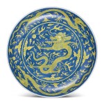 A LARGE BLUE-GROUND AND YELLOW-ENAMELLED 'DRAGON' DISH SEAL MARK AND PERIOD OF DAOGUANG | 清道光 藍地黃彩戲珠龍紋盤 《大清道光年製》款
