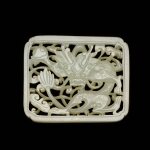 A reticulated white jade 'dragon' plaque, Ming dynasty | 明 白玉鏤雕龍紋帶板