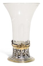 AN ITALIAN GLASS BEAKER WITH CONTINENTAL PARCEL-GILT SILVER FOOT MOUNT, UNMARKED, CIRCA 1630