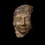 A Fragmentary Egyptian Polychrome Limestone Sarcophagus Mask, 30th Dynasty/early Ptolemaic Period, circa 380-250 B.C.