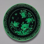 A BLACK-GROUND GREEN-ENAMELLED 'BUTTERFLY AND FLOWER' DISH, QIANLONG SEAL MARK AND PERIOD | 清乾隆 黑地綠彩蝶戀花紋盤 《大清乾隆年製》款