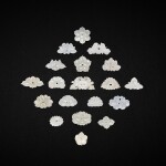 A group of thirty four white and pale celadon jade flower ornaments, Yuan - Qing dynasty 元至清 白玉及青玉雕花形飾件一組三十四件