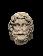 A ROMAN MARBLE HEAD OF A GOD, CIRCA 2ND CENTURY A.D.