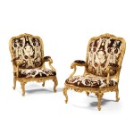 A pair of Austrian rococo carved giltwood armchairs, Vienna, mid-18th century