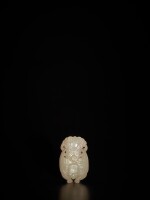 A pale celadon jade 'Garuda' slide, Qing dynasty | 清 青白玉雕迦樓羅飾