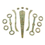 A group of 13 gold and hardstone-inlaid bronze chariot harness fittings, Western Han dynasty | 西漢 青銅錯金嵌寶車馬飾一組十三件