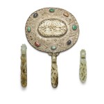 Three celadon jade belthooks, one mounted as a mirror handle, and a jade butterfly plaque The jade belt hooks, Qing dynasty, 18th century, the plaque 19th century | 玉帶鈎為清十八世紀 青白玉帶鈎一組三件，其中一件被後配為執鏡