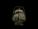 An extremely rare and important archaic bronze ritual wine vessel and cover, you, Shang dynasty, Yinxu period |  商代殷墟時期 青銅饕餮紋卣