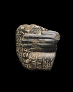 An Egyptian Granite or Basalt Healing Block Statue Fragment, Late Period, circa 4th Century B.C.