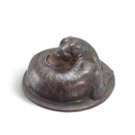 A silver-inlaid bronze 'tiger' weight, Han dynasty 漢 銅錯銀盤虎形鎮