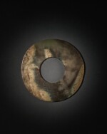 An archaic mottled brown and celadon jade disc (Bi), Neolithic period, Qijia culture | 新石器時代 齊家文化 玉璧