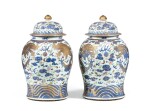 A rare pair of gilt-decorated blue and white and famille rose 'dragon' vases and covers Qing dynasty, 18th-19th century | 清十八至十九世紀 描金青花粉彩雙龍戲珠紋將軍瓶一對