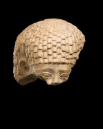 A Fragmentary Egyptian Indurated Limestone Head of a Man, 26th Dynasty, 664-525 B.C.