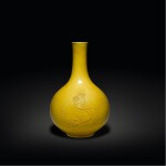 A carved yellow-glazed 'chilong' bottle vase, Qing dynasty | 清 黃釉刻螭龍紋瓶