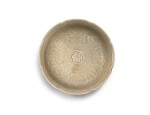 A rare lobed celadon 'auspicious objects' dish Yuan dynasty | 元 青釉印雜寶紋花口盤