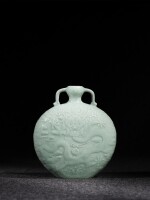 A superb and possibly unique celadon-glazed 'dragon' moon flask, Seal mark and period of Qianlong | 清乾隆 粉青釉浮雕海水龍紋雙耳扁壺 《大清乾隆年製》款