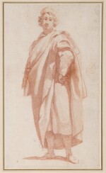 A young man standing, his hand on his hip