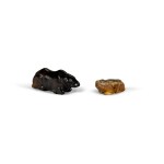 A black stone figure of a recumbent buffalo and a mottled jade figure of a small bear/dog Qing dynasty | 清 黑石臥牛 及 青玉犬 一組兩件