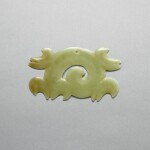 A yellowish-celadon jade 'cloud' pendant, Neolithic period, Hongshan culture | 新石器時代 紅山文化 青黃玉勾雲珮 